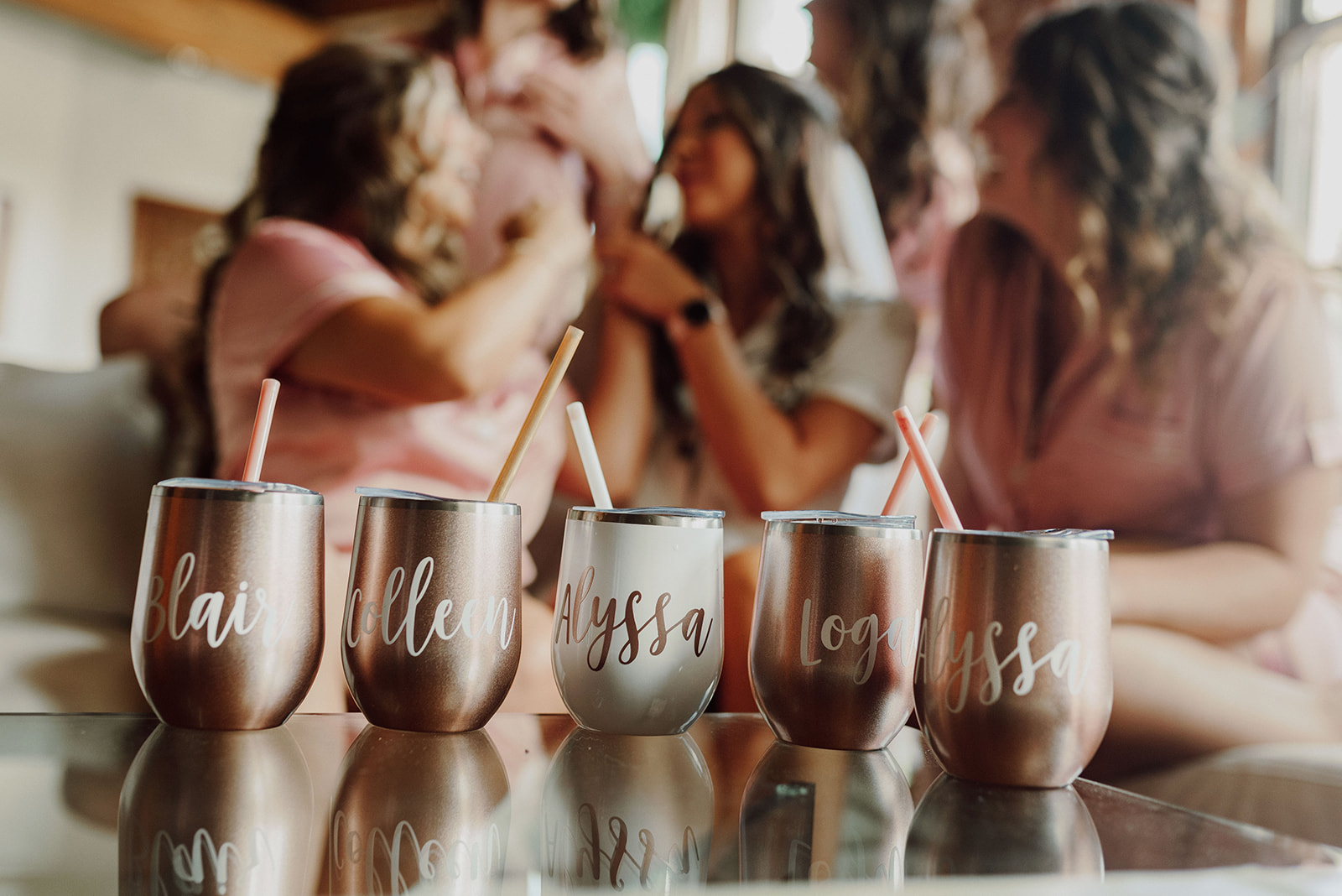 8 Bachelorette Party Themes and Ideas: Bride and her bridesmaids during talking during their bachelorette party with cups with their names on it in front of them
